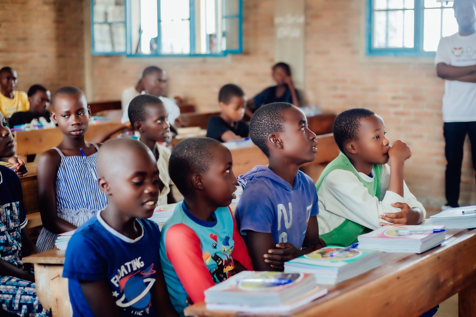Teacher assisting students in a Rising Star Academy classroom